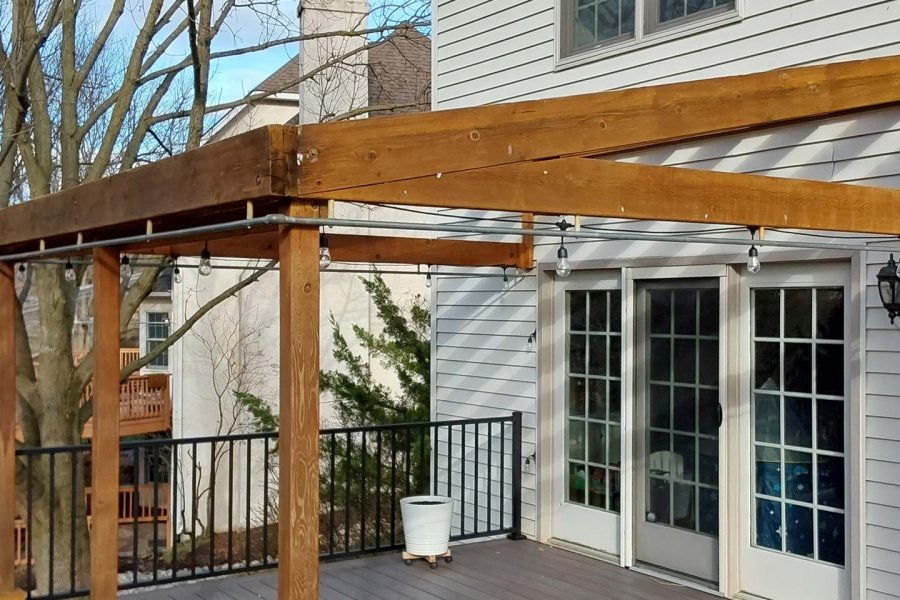 An outdated pergola attached to a deck