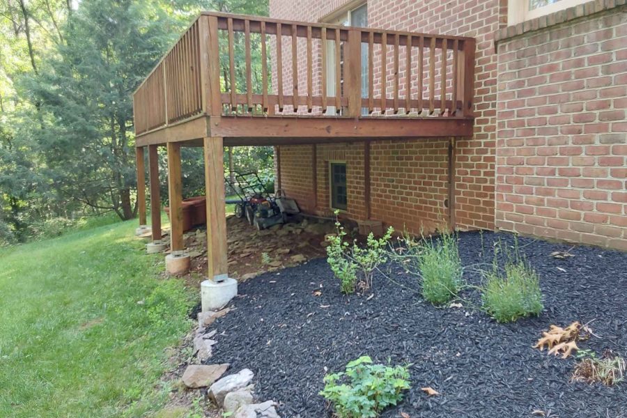 A deck on risers before replacement by deck contractors